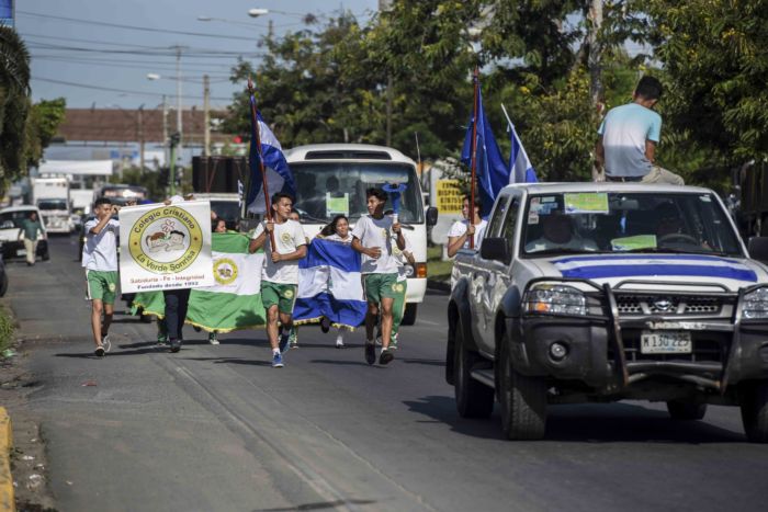Quitan bandera de Nicaragua a joven que la portaba sobre su espalda