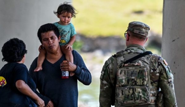 Getty Images Un hombre con su hija en los hombros en la frontera.