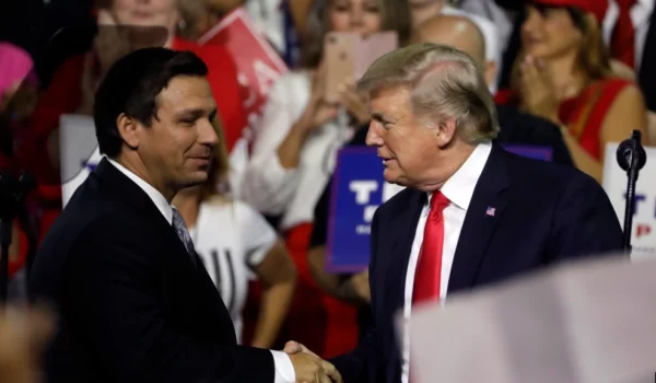 ARCHIVO - El presidente Donald Trump, a la derecha, le da la mano al candidato republicano a gobernador de Florida, Ron DeSantis, durante un mitin en Tampa, Florida, el 31 de julio de 2018.