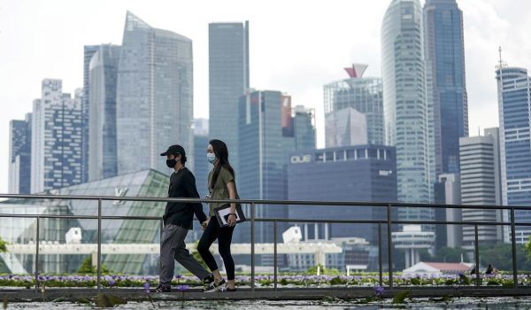 Una pareja pasea ante el distrito financiero de Singapur, en una imagen tomada el 28 de abril de 2021. EFE/EPA/WALLACE WOON