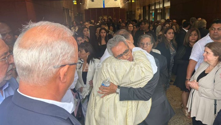 El padre Benito Martínez consuela a Dennis ante la pérdida de su esposa. LA PRENSA