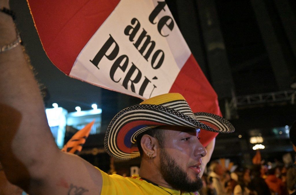 Un simpatizante de la candidata presidencial peruana Keiko Fujimori, del derechista partido Fuerza Popular, despliega una bandera que dice "Te amo Perú". AFP / MARTIN BERNETTI