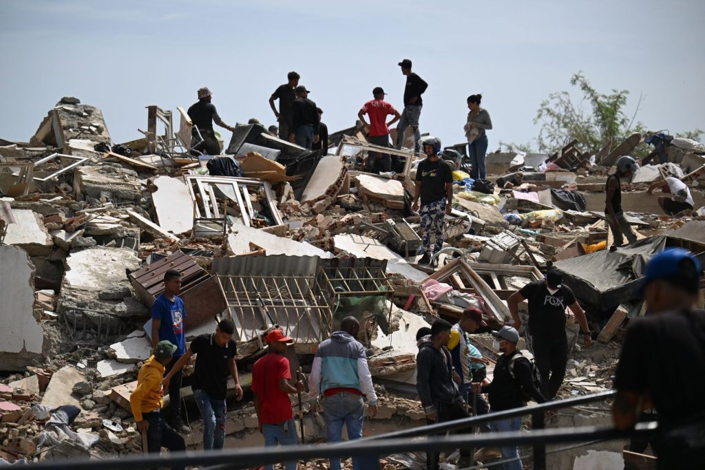 Un grupo de rescatistas busca sobrevivientes en este edifico colapasado en Catia La Mar, en la Guaira. FEDERICO PARRA/AFP