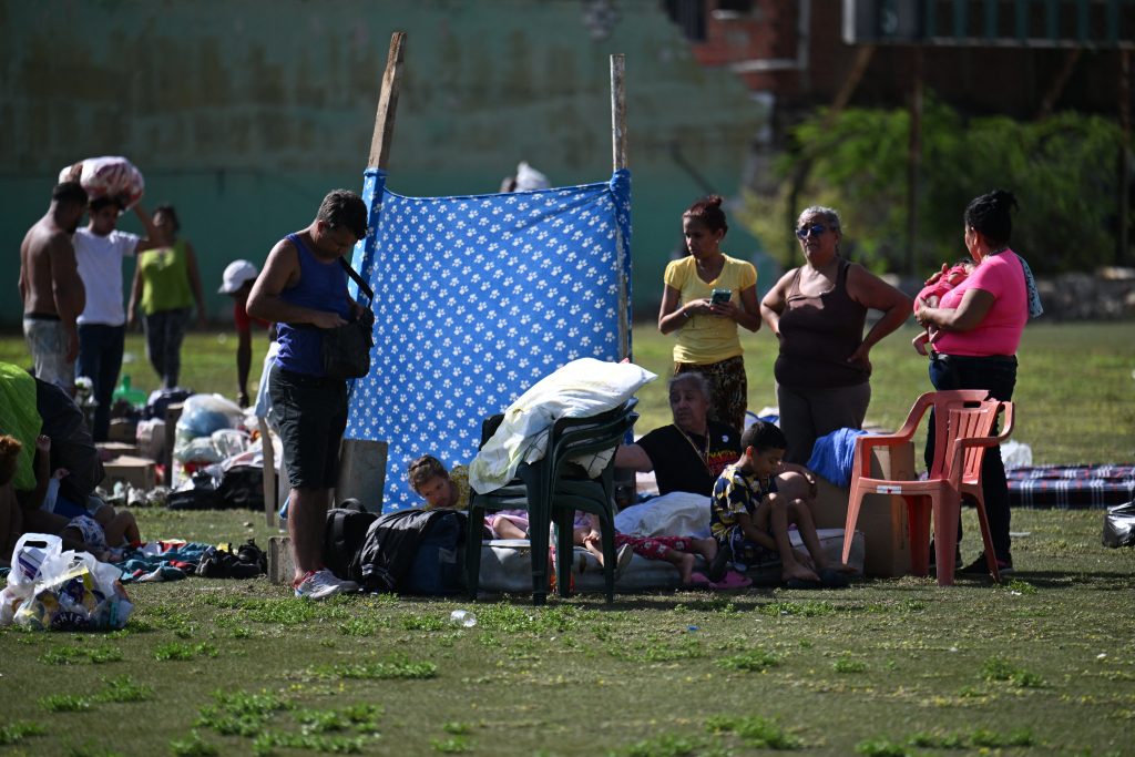 Familias locales han hallado refugio temporal en un estadio deportivo en Catia La Mar, estado de La Guaira. FEDERICO PARRA/AFP
