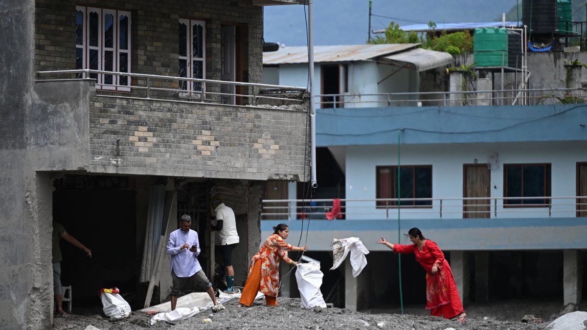 Residentes recuperan sus pertenencias tras las inundaciones repentinas ocurridas en el centro de Trishuli, en el distrito nepalí de Nuwakot, el 30 de agosto de 2026. (Foto de Arun SANKAR / AFP)